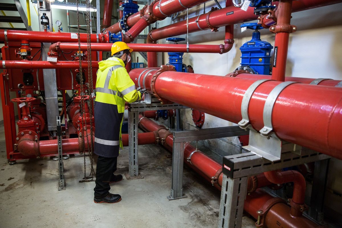 Engineer inspecting an industrial piping system